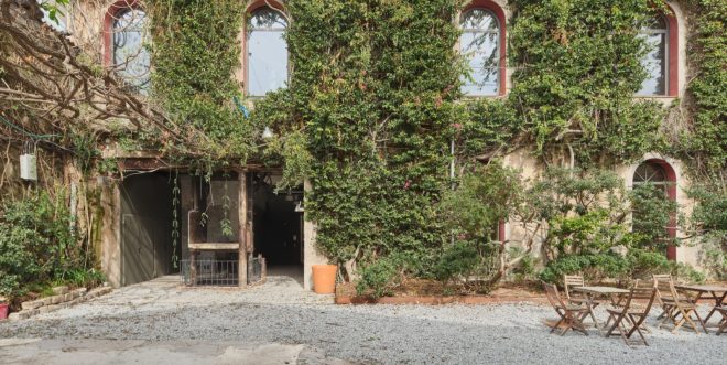 Archisearch - A Whimsical Reuse: Taller 9s Transforms a 19th-Century Barcelona Warehouse into a Business Incubator While Preserving Its Historic Green Façade.