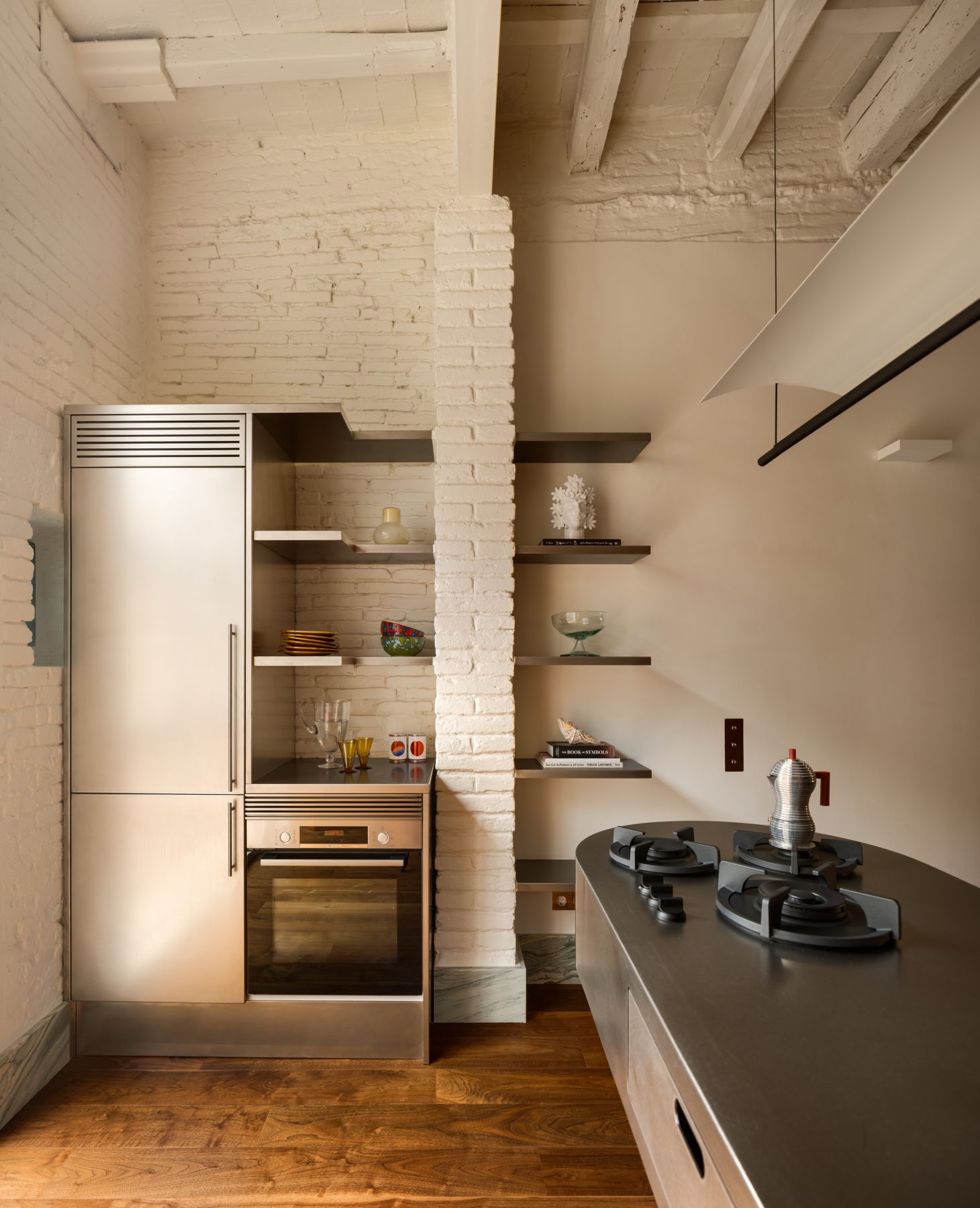 Archisearch Interiors We Love: RiC 12 by Serboli is A Duplex in Barcelona Unfolding Around a Signature Red Spiral Staircase