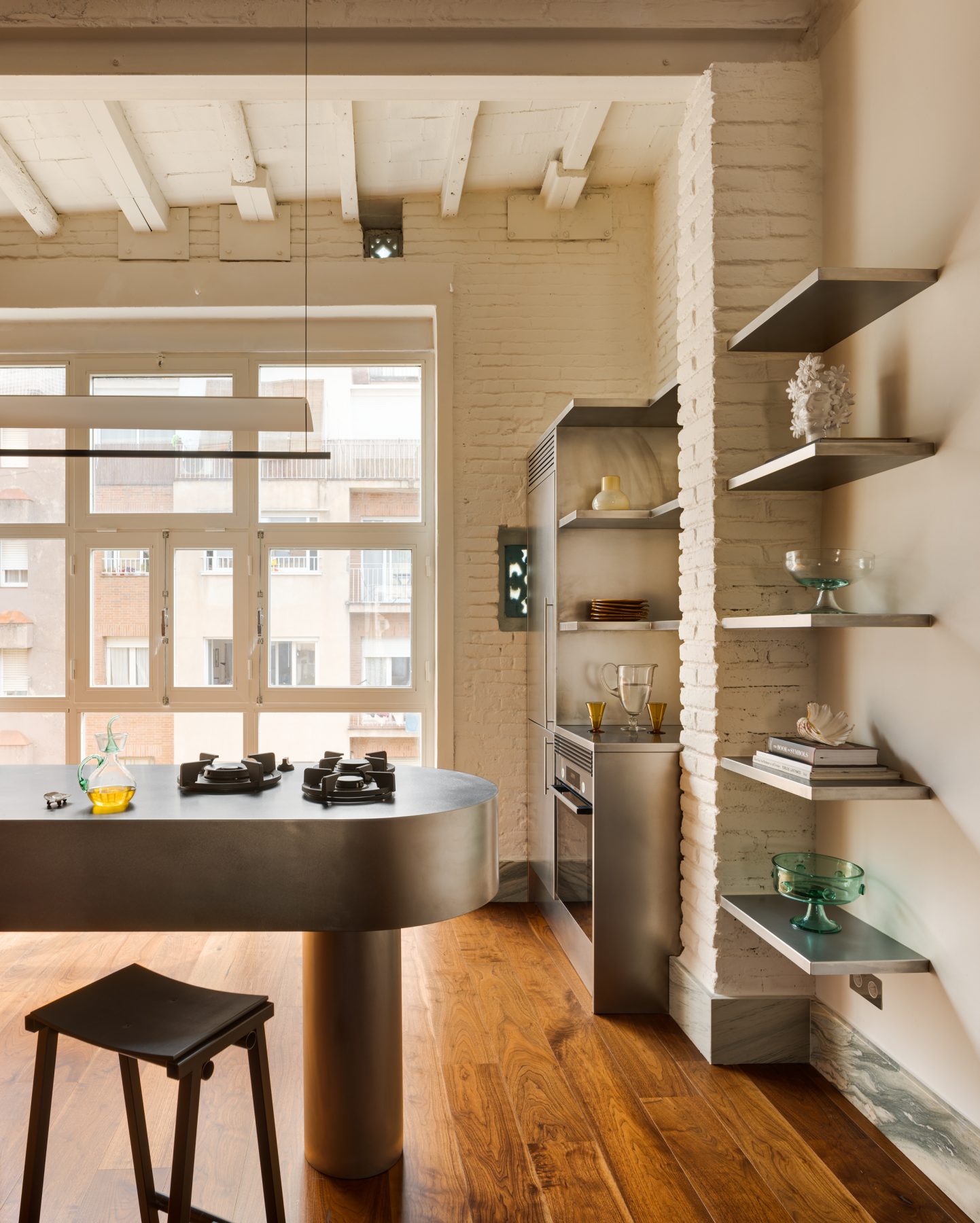 Archisearch Interiors We Love: RiC 12 by Serboli is A Duplex in Barcelona Unfolding Around a Signature Red Spiral Staircase
