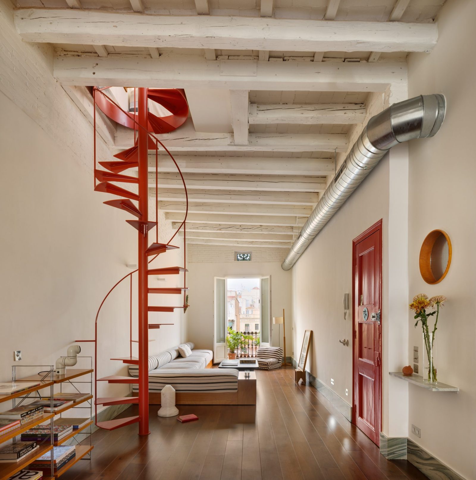 Archisearch Interiors We Love: RiC 12 by Serboli is A Duplex in Barcelona Unfolding Around a Signature Red Spiral Staircase