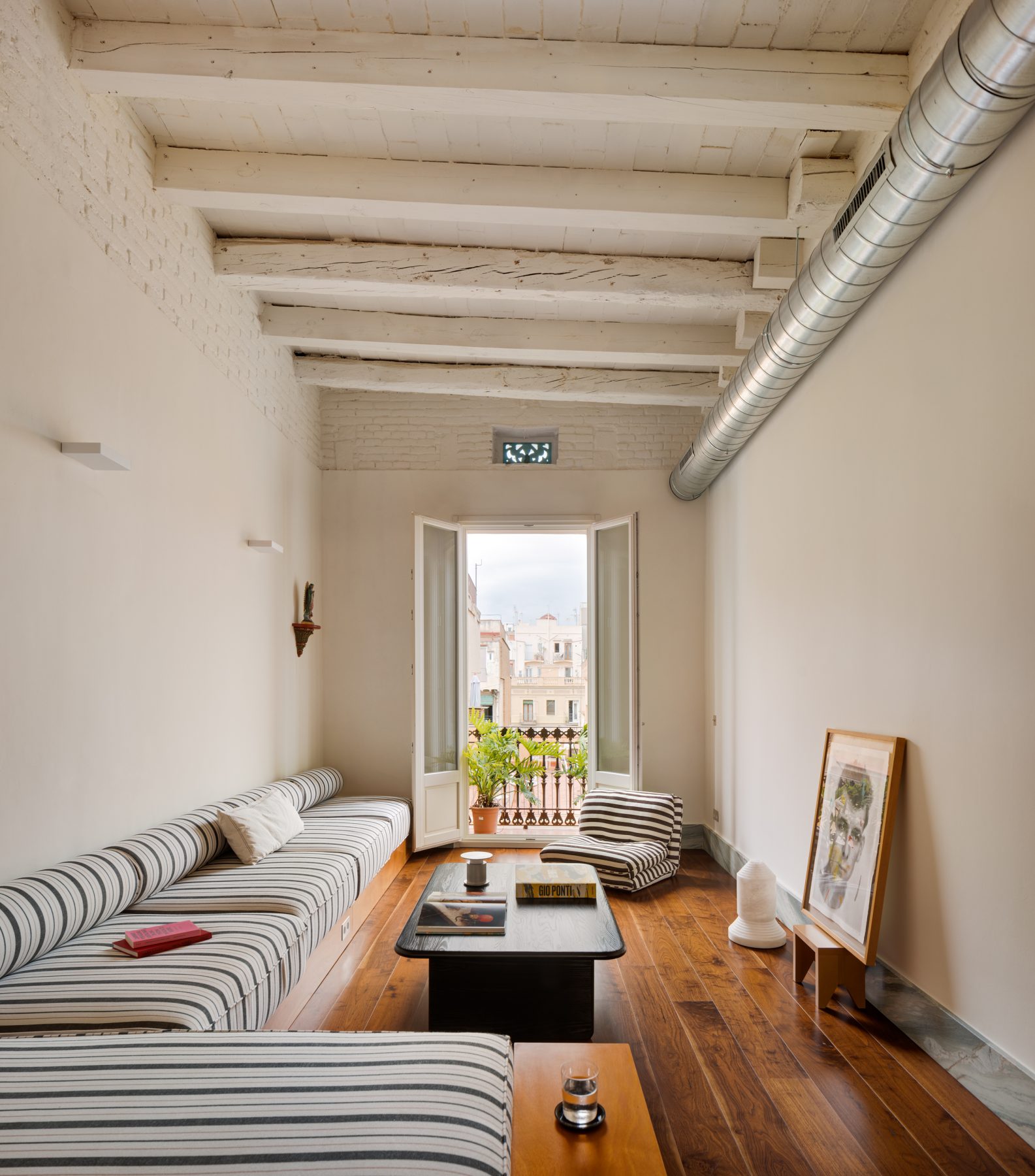 Archisearch Interiors We Love: RiC 12 by Serboli is A Duplex in Barcelona Unfolding Around a Signature Red Spiral Staircase