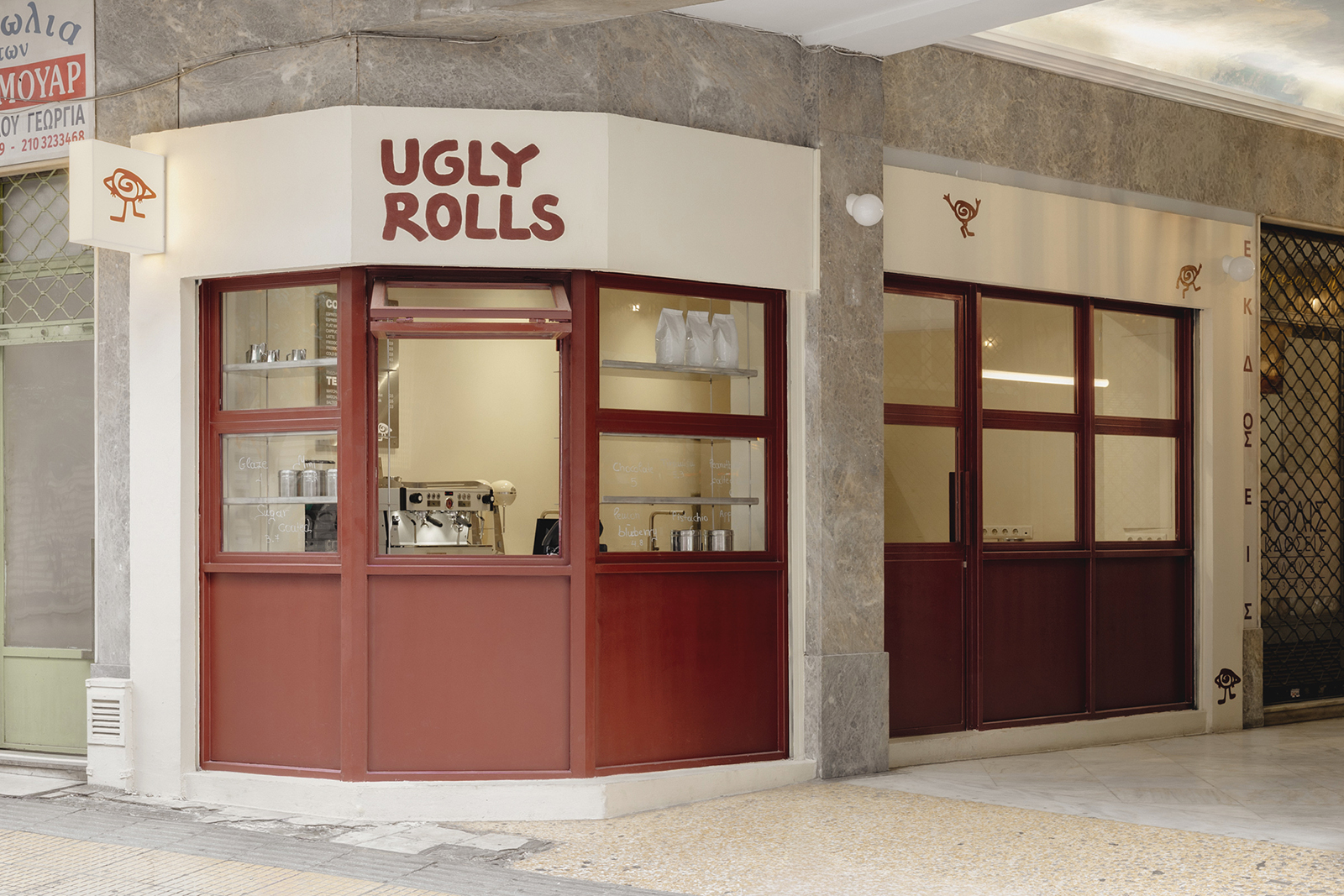 Archisearch Georgios Apostolopoulos designs Ugly Rolls, a tiny corner shop in Athens with cinnamon-toned maroon framing