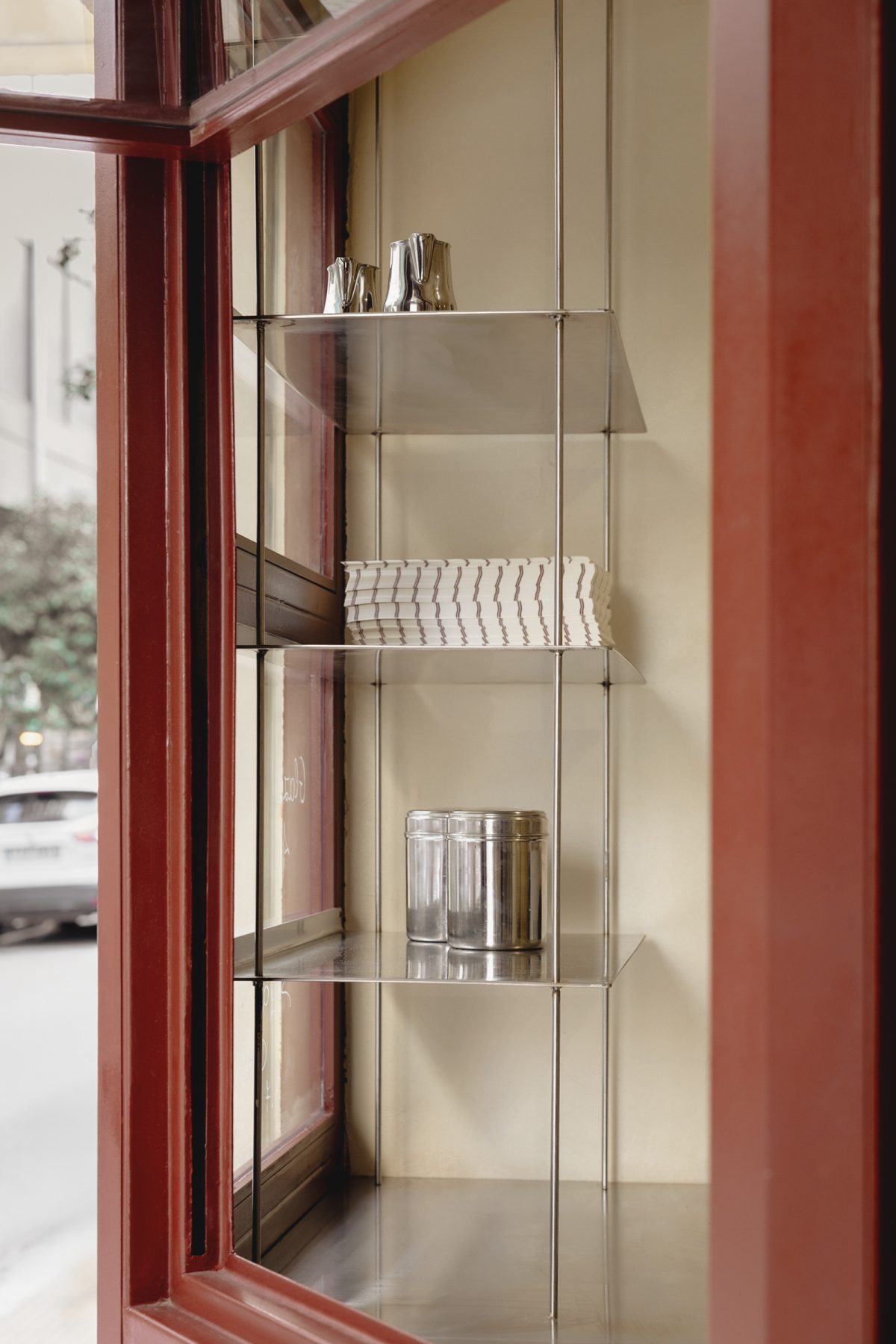 Archisearch Georgios Apostolopoulos designs Ugly Rolls, a tiny corner shop in Athens with cinnamon-toned maroon framing