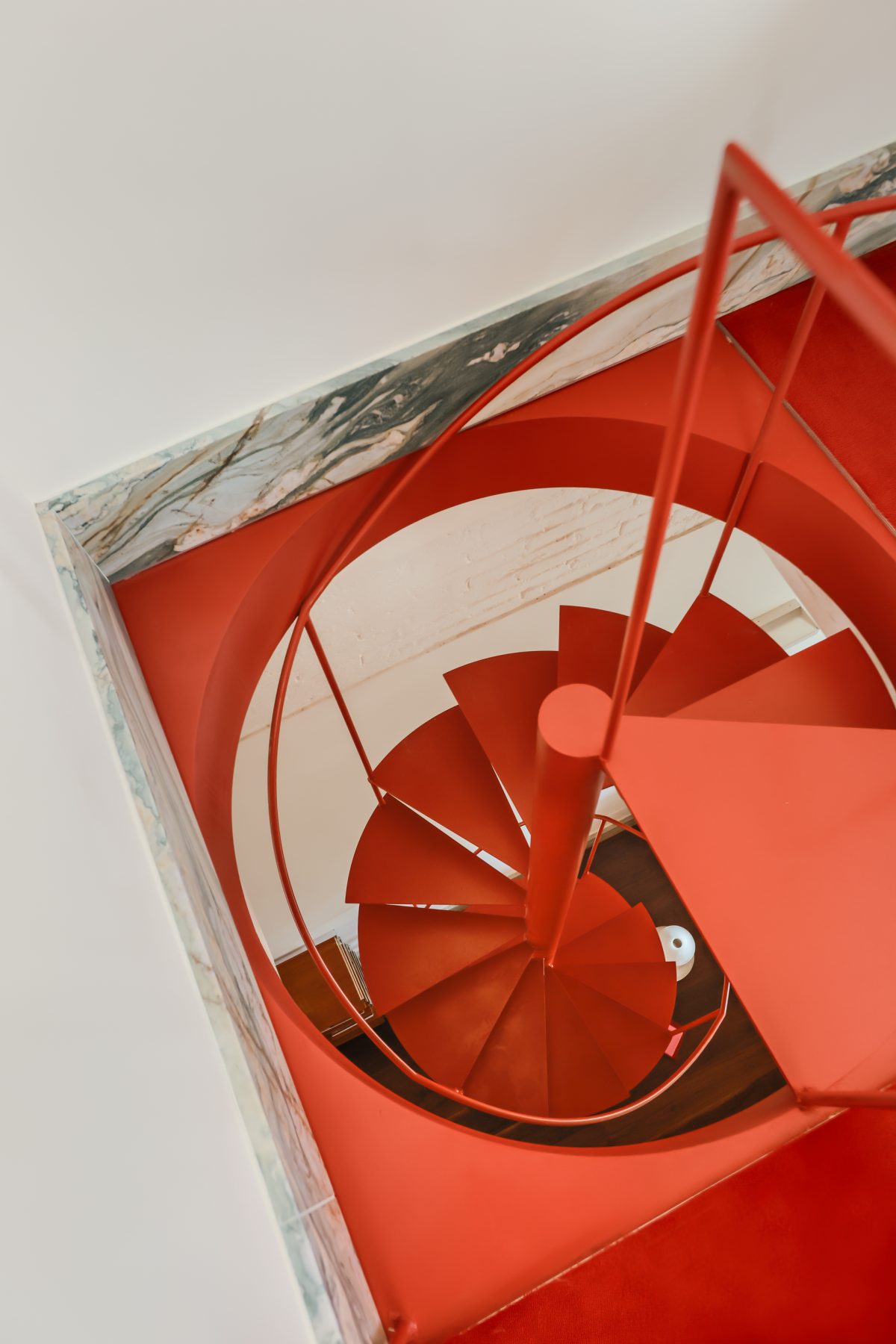 Archisearch Interiors We Love: RiC 12 by Serboli is A Duplex in Barcelona Unfolding Around a Signature Red Spiral Staircase