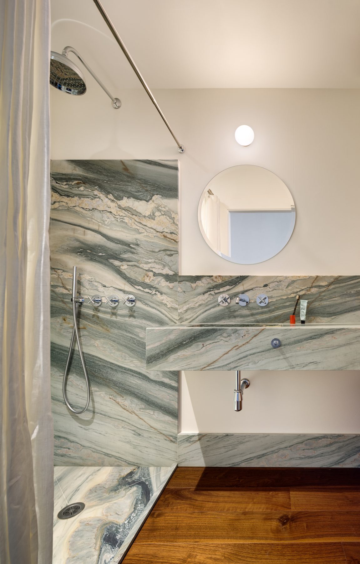 Archisearch Interiors We Love: RiC 12 by Serboli is A Duplex in Barcelona Unfolding Around a Signature Red Spiral Staircase