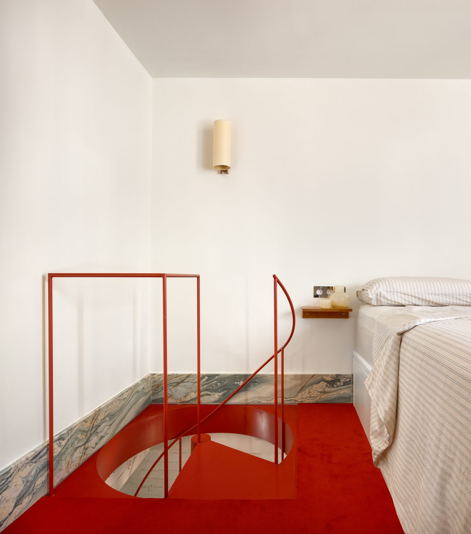 Archisearch Interiors We Love: RiC 12 by Serboli is A Duplex in Barcelona Unfolding Around a Signature Red Spiral Staircase