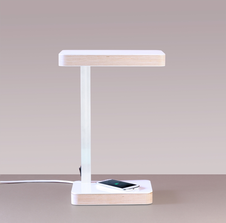 Archisearch - LightPlus Qi is a lamp in laminated plywood that hides inside it a low-consumption LED and a wireless charging system.